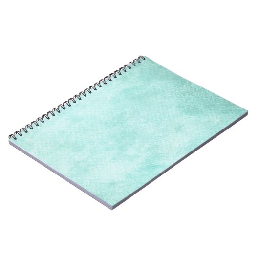 淡いブルーの緑の水彩画の紙の背景のブランク ノートブック (左側)
