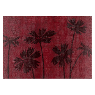 深紅色の背景のFlowerheadのシルエット カッティングボード