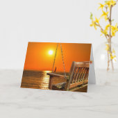 湖に沈む夕日を背景にした木製のブランコ カード (黄色い花)