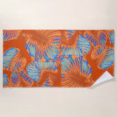 燃えたオレンジ色と電気ブルーのトロピカル葉 ビーチタオル (正面)