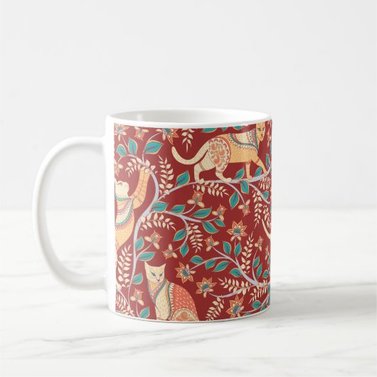 猫とオーナメント、枝に花と葉 コーヒーマグカップ (左)