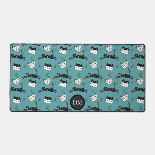 猫の顔おもしろいをティール(緑がかった色)モノグラムでジャンプ デスクマット (正面)