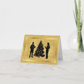 男性と女性の医者のシルエットがクリスマスツリーとともに明るい金色の背景にデザインされたクリスマスカー カード (正面)