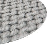 白いニットのウールのテクスチャ、クローズアップ写真。 カッティングボード (角)