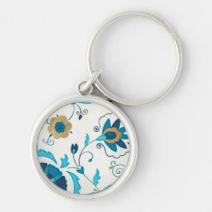 白い背景が付いている金めっきされたインディゴの花 キーホルダー