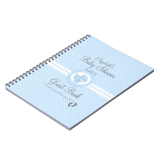 白人のスイス人が付いている青はベビーシャワーの来客名簿に点を打ちます ノートブック (左側)