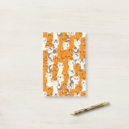 白猫と生姜の猫が緑の目を青く描く ポストイット (デスク上)