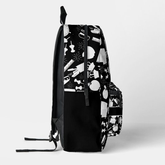 白黒の学校用品のパターン プリントバックパック (左)