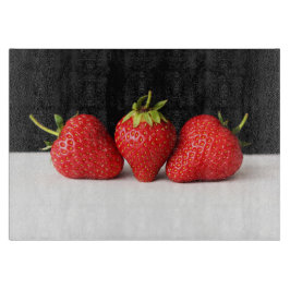 白Cbcnaの上の黒のイチゴ カッティングボード