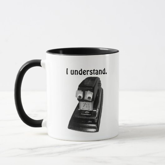 目がギリギリしたホッチキス マグカップ (左)