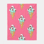 目の付いた青いアイスクリーム。ピンクの背景。シームルズ フリースブランケット (正面)