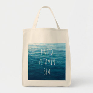 私はビタミンの海の背景が付いている海のトートバックを必要とします トートバッグ