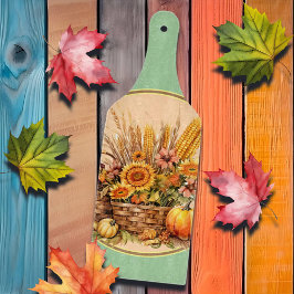 秋のバスケット、花、かぼちゃ、トウモロコシのシャベル カッティングボード