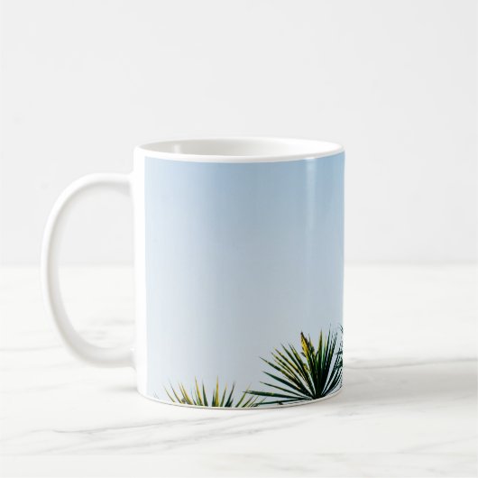 空の下に緑の葉が澄ん植わる コーヒーマグカップ (左)