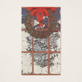 窓に飾られた雪の降るクリスマスのリース (正面)