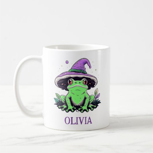 紫の魔女の帽子をかぶった緑のカエル コーヒーマグカップ (左)