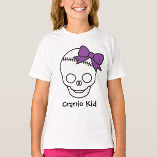 紫色の弓が付いているCranioの子供のガーリーなスカル Tシャツ