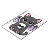 紫色の羽を持つ黒猫がドクロを抱っこ ノートブック (左側)