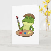 絵筆と絵の具を持つ画家としてのカエル カード (黄色い花)