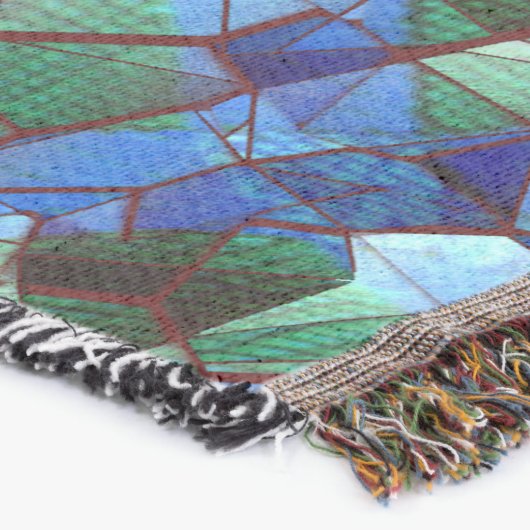 緑と青の不規則なモザイクが重ねられた乱雑な スローブランケット (コーナー)