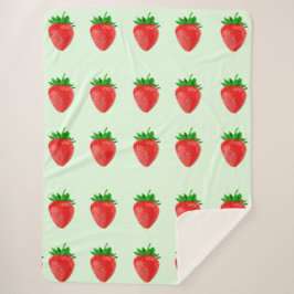 緑のシャーブルケットの上のイチゴ シェルパブランケット