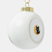 緑の目を浮かべて白熱［赤熱］光を放つ微笑む黒猫 セラミックボールオーナメント (左)