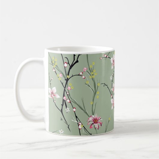 緑の背中に小さな赤と黄色の花模様 コーヒーマグカップ (左)
