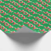 緑の背景に雪の結晶が舞うJOYのテキスト ラッピングペーパー (角)