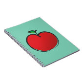 緑の背景の大きな赤い淡い色のリンゴスケッチ ノートブック (右側)