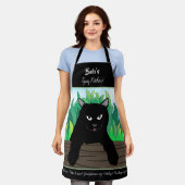 緑の草が生い茂ったフェンスの上の黒猫 エプロン (着用した状態)