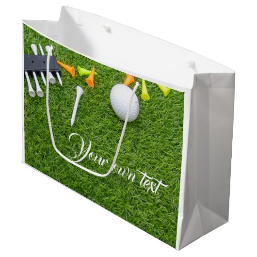 緑の草にカラフルティーを付けたゴルフボール ラージペーパーバッグ (正面アングル)