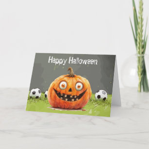 緑の草の上にボールを持つサッカーハッピーハローウィン カード