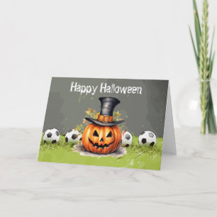 緑の草の上にボールを持つサッカーハッピーハローウィン カード