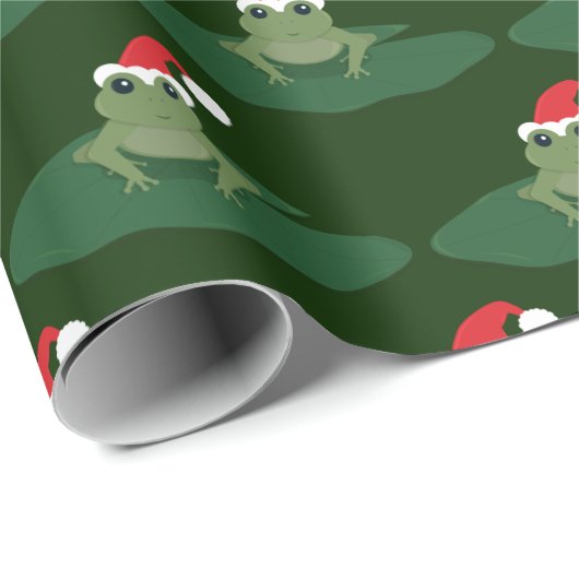 緑カエルのサンタの帽子のスイレンの浮いている葉のノベルティのクリスマス ラッピングペーパー (ロールコーナー)