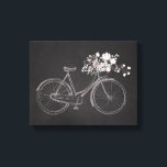 美しいピンクと白の花を持つヴィンテージバイク キャンバスプリント<br><div class="desc">美しいヴィンテージの水色のバイクと黒い黒板の背景に明るいピンクと白い花のバスケットを持つキャンバスは、あらゆる年齢の女性に最適である。</div>