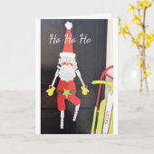 聖降誕祭ぶら下がったお目出度うサンタクロース カード (黄色い花)