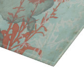 背景に赤い花のシルエットティール(緑がかった色) カッティングボード (角)