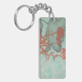 背景に赤い花のシルエットティール(緑がかった色) キーホルダー (正面左)