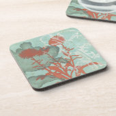 背景に赤い花のシルエットティール(緑がかった色) コースター (左側)