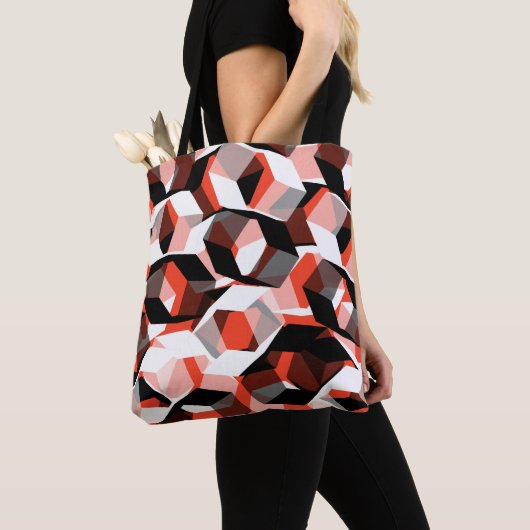 色の変わった部分を持つ多数の六角形、明るい赤 トートバッグ (クローズアップ)