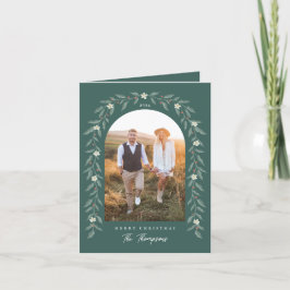 花のガーランドがアーチ状に写る 緑のクリスマスカード シーズンカード