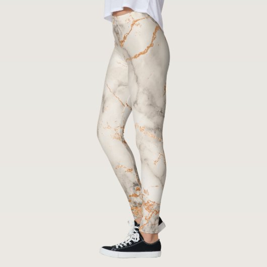 茶色のアクセントと白の抽象芸術パターン レギンス (左)