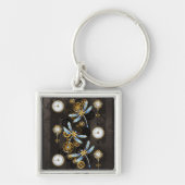 茶色の背景にスチームパンク・ドラゴストライプのンバエ キーホルダー (正面)