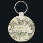葉に囲まれた美しいヴィンテージの白い鳩 キーホルダー<br><div class="desc">美しいヴィンテージの白い鳩の葉の運平和の旗の黒と白に囲まれた</div>