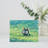 薄緑の牧草地で目を見開く黒猫 ポストカード (スタンド正面)