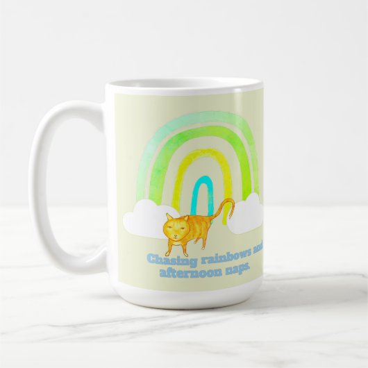 虹を追いかけて昼寝する かわいい茶トラ猫 コーヒーマグカップ (左)