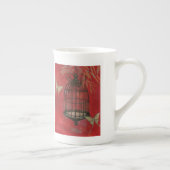 蝶と装飾的な鳥かご ボーンチャイナマグカップ (右)