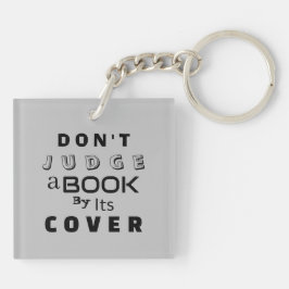 「表紙で判断するな」ライトグレー キーホルダー