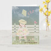 誕生日に凧を持つ少女がベンチに座る カード (黄色い花)
