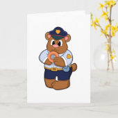 警察官のユニフォームを着たドーナツを持つクマ カード (黄色い花)